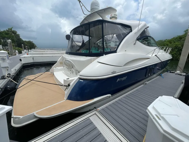 Slide: The Image of 2005 Cruisers Yachts 500 Express docked, showcasing sleek design and spacious deck. - 8
