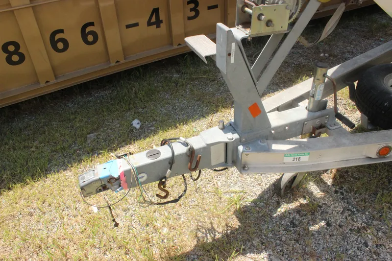Slide: The Image of Trailer hitch of a 2011 Ranger 2400 Bay Ranger boat on grass. - 10