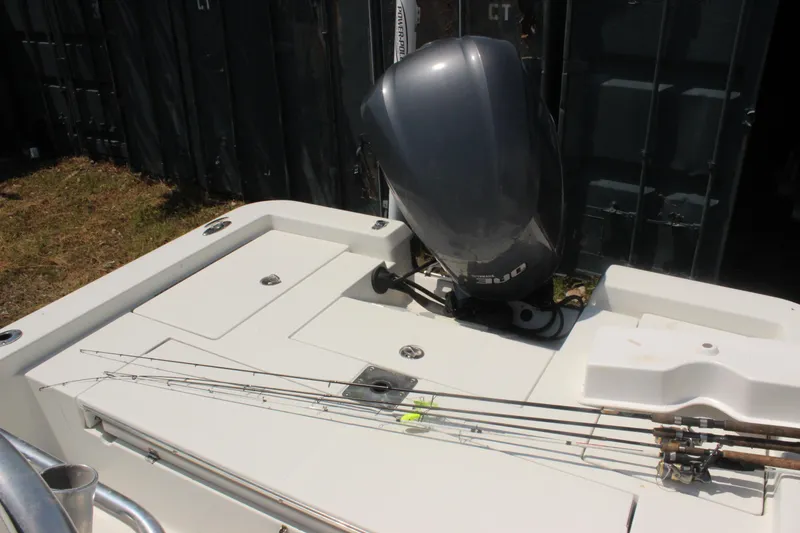 Slide: The Image of 2011 Ranger 2400 Bay Ranger boat with fishing rods and outboard motor. - 17