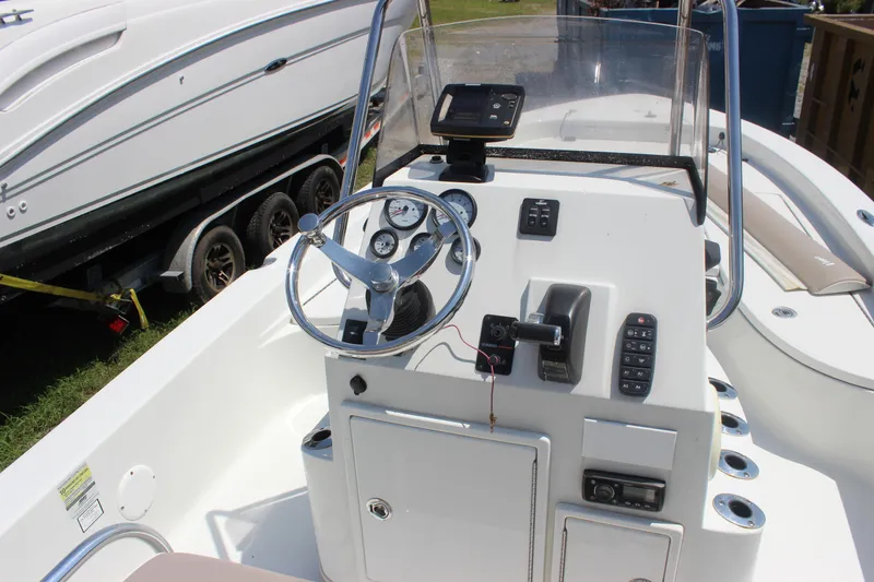 Slide: The Image of 2011 Ranger 2400 Bay Ranger boat console with steering wheel and controls. - 20