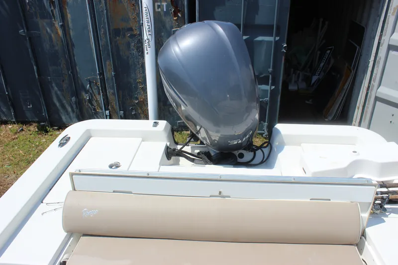 Slide: The Image of 2011 Ranger 2400 Bay Ranger boat with outboard motor and beige seating. - 21