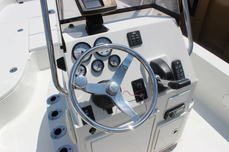 Slide: The Image of 2011 Ranger 2400 Bay Ranger boat console with steering wheel and gauges. - 25
