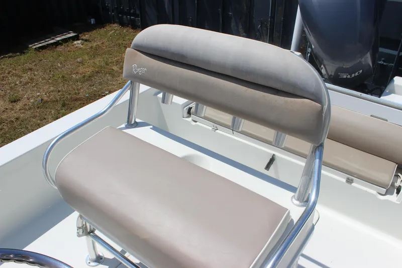 Slide: The Image of 2011 Ranger 2400 Bay Ranger boat seat with beige cushions and metal frame. - 26