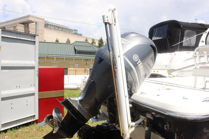 Slide: The Image of 2011 Ranger 2400 Bay Ranger with Yamaha outboard motor, docked outdoors. - 4