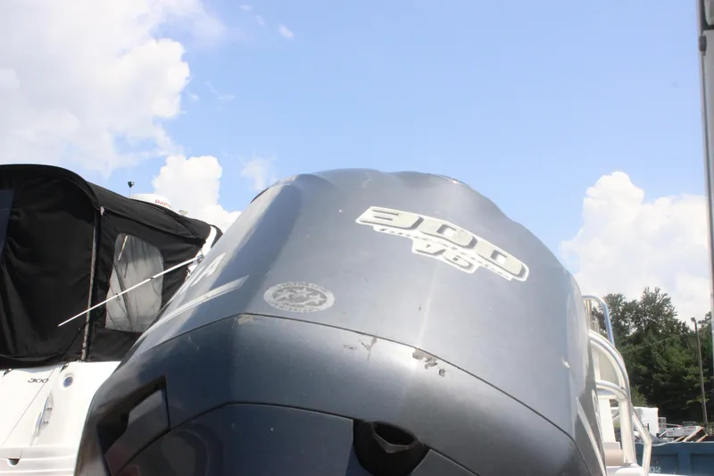 Slide: The Image of Outboard motor on a 2011 Ranger 2400 Bay Ranger boat under a clear sky. - 6