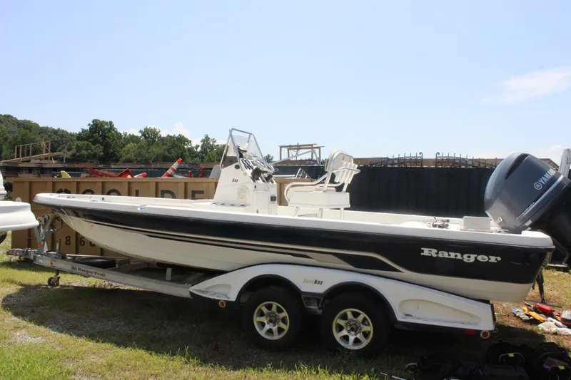 Slide: The Image of 2011 Ranger 2400 Bay Ranger boat on trailer, parked outdoors. - 7