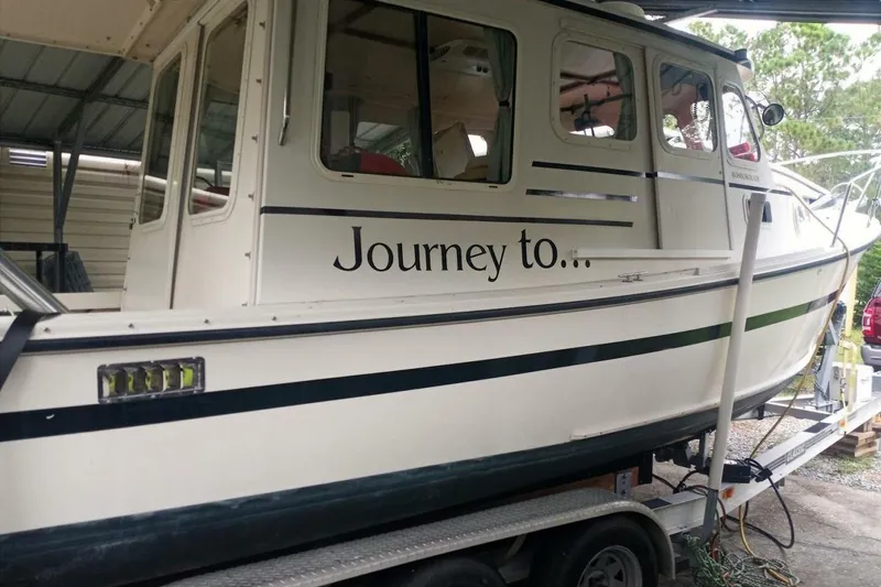 Slide: The Image of 2005 Rosborough RF-246 Sedan Cruiser on trailer, featuring "Journey to..." text on side. - 10