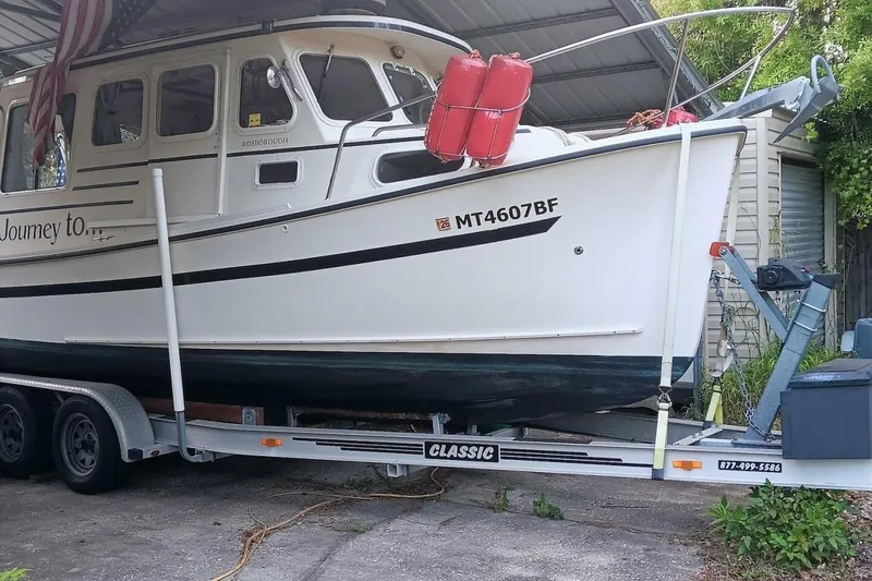 Slide: The Image of 2005 Rosborough RF-246 Sedan Cruiser on trailer, parked under a shelter. - 15