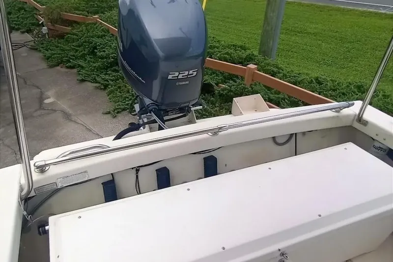 Slide: The Image of 2005 Rosborough RF-246 Sedan Cruiser with Yamaha 225 outboard motor, docked near greenery. - 17