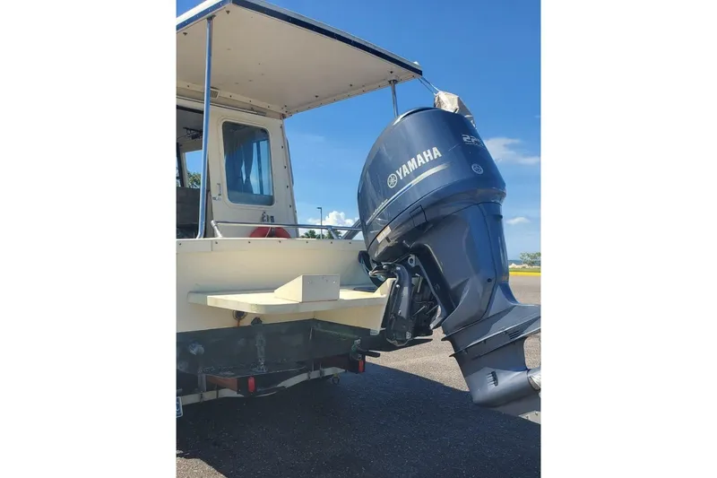 Slide: The Image of 2005 Rosborough RF-246 Sedan Cruiser with Yamaha outboard motor, docked under clear blue sky. - 20
