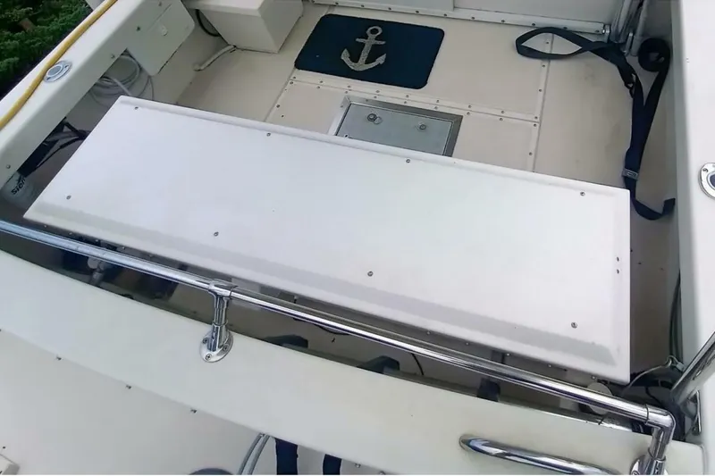 Slide: The Image of 2005 Rosborough RF-246 Sedan Cruiser deck with anchor mat and storage compartments. - 23