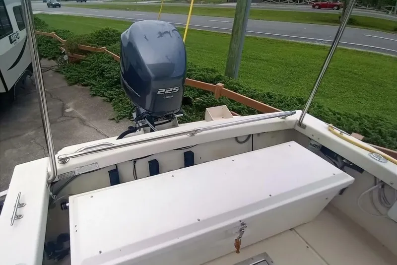 Slide: The Image of 2005 Rosborough RF-246 Sedan Cruiser with Yamaha 225 outboard motor, docked near a road. - 25