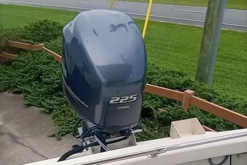 Slide: The Image of Yamaha 225 outboard motor on 2005 Rosborough RF-246 Sedan Cruiser, parked near greenery. - 3
