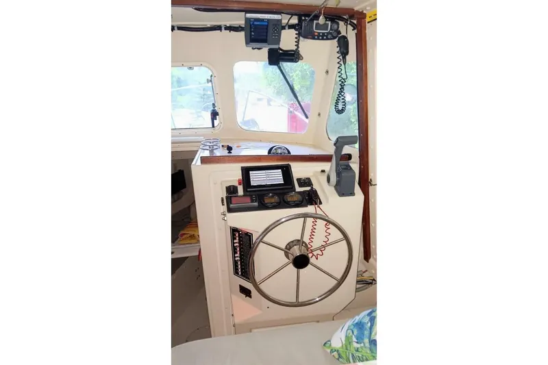 Slide: The Image of 2005 Rosborough RF-246 Sedan Cruiser helm with steering wheel and navigation equipment. - 36