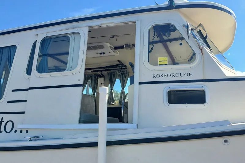 Slide: The Image of 2005 Rosborough RF-246 Sedan Cruiser with open cabin door and visible interior. - 4