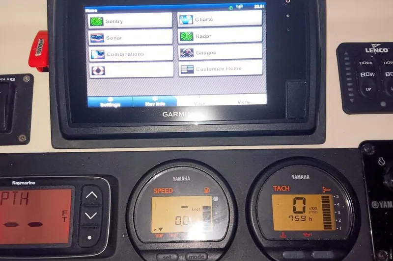 Slide: The Image of 2005 Rosborough RF-246 Sedan Cruiser dashboard with Garmin navigation and Yamaha gauges. - 44