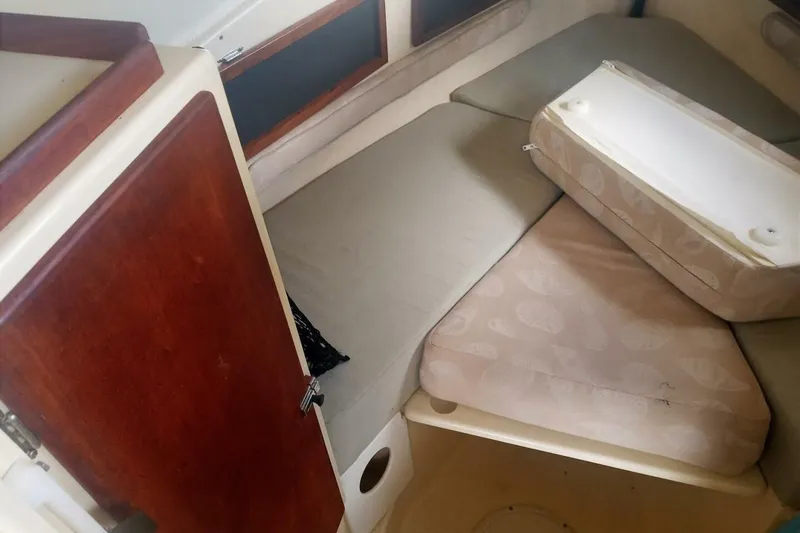 Slide: The Image of 2005 Rosborough RF-246 Sedan Cruiser cabin interior with cushions and wooden door. - 52