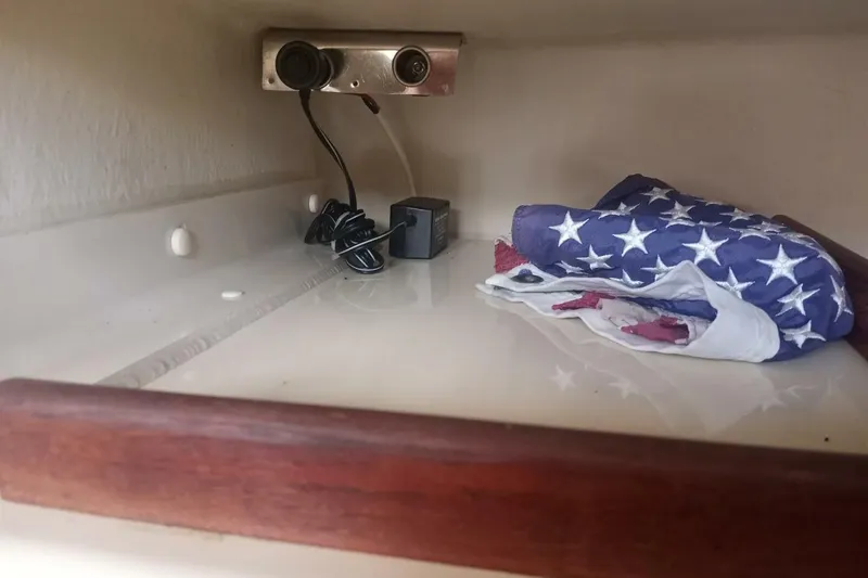Slide: The Image of Storage shelf in 2005 Rosborough RF-246 Sedan Cruiser with folded American flag and electrical outlet. - 53