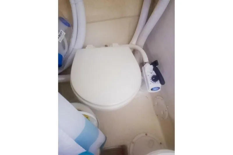 Slide: The Image of 2005 Rosborough RF-246 Sedan Cruiser marine toilet with manual pump handle. - 58