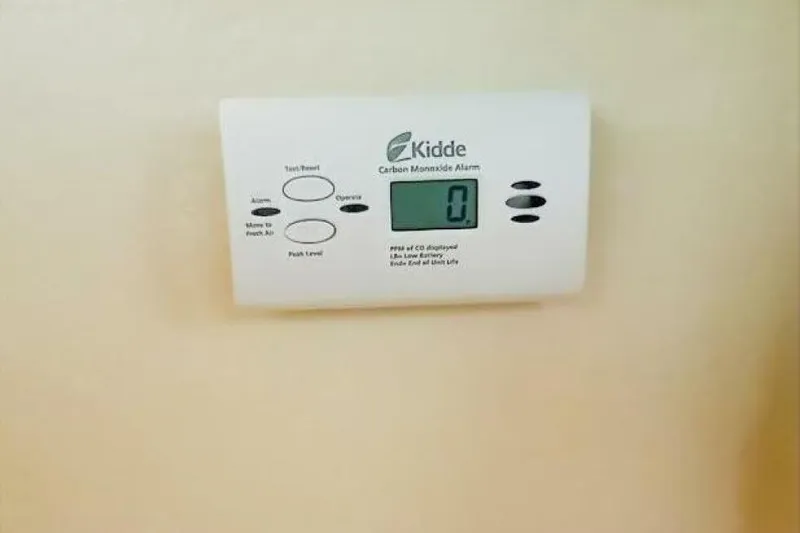Slide: The Image of Kidde carbon monoxide alarm displaying zero, mounted on a wall. - 59