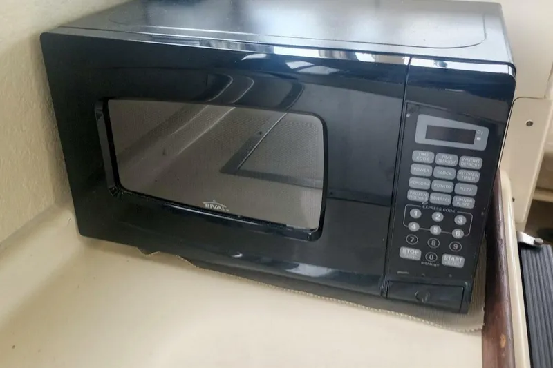 Slide: The Image of Black microwave oven inside 2005 Rosborough RF-246 Sedan Cruiser. - 62