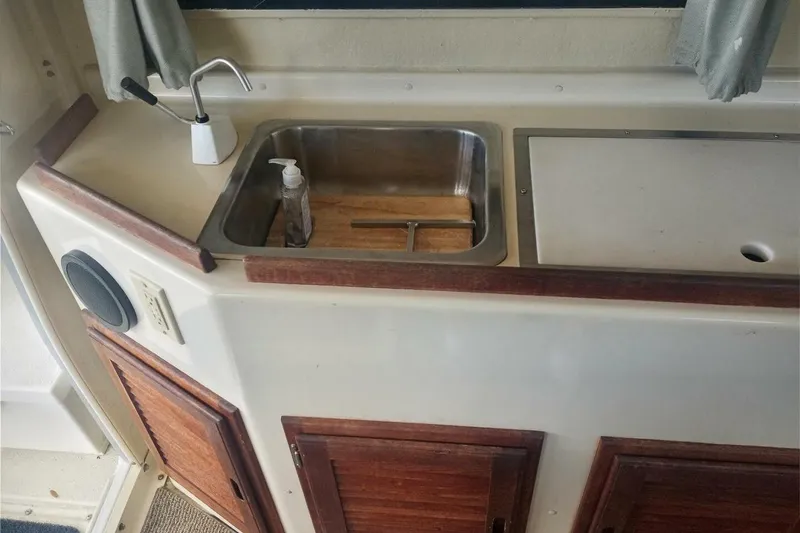 Slide: The Image of 2005 Rosborough RF-246 Sedan Cruiser interior with sink and wooden cabinetry. - 63