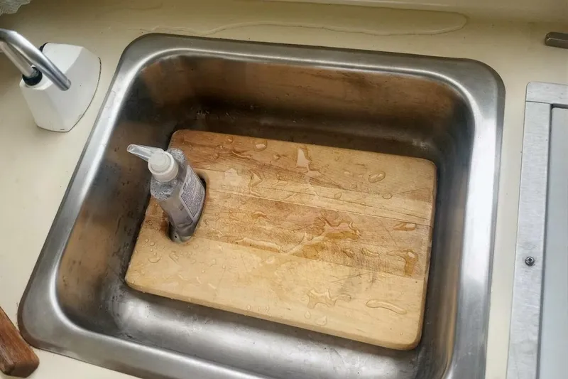 Slide: The Image of Stainless steel sink with wooden cutting board and soap bottle, Rosborough RF-246 Sedan Cruiser, 2005. - 64