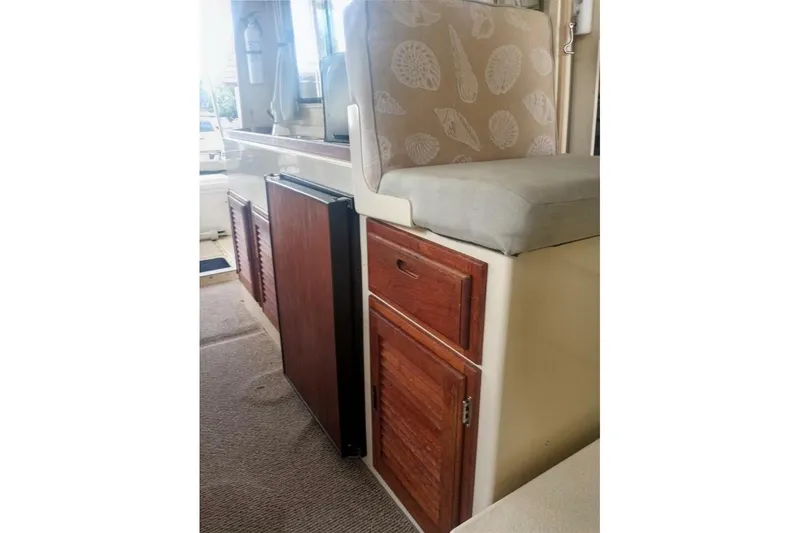 Slide: The Image of 2005 Rosborough RF-246 Sedan Cruiser interior with wooden cabinets and cushioned seating. - 66