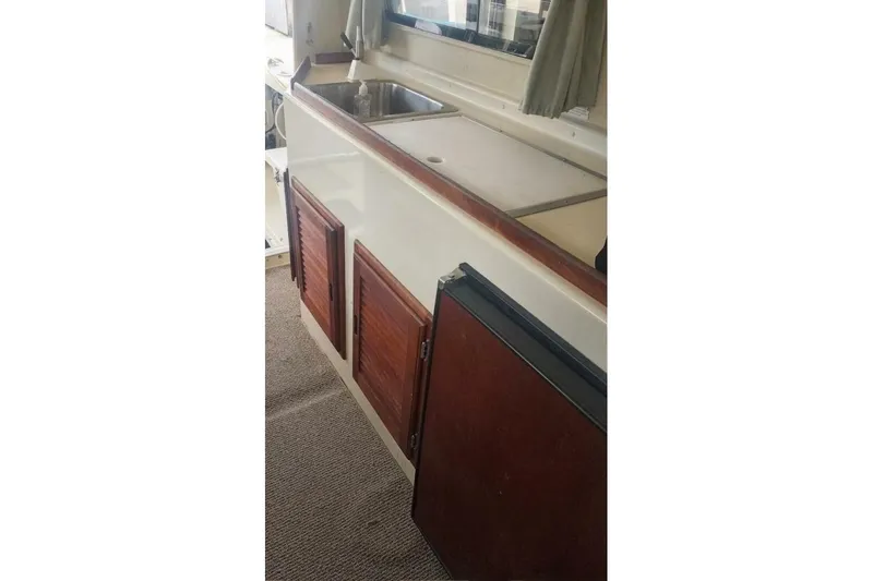 Slide: The Image of 2005 Rosborough RF-246 Sedan Cruiser interior with sink and wooden cabinets. - 67