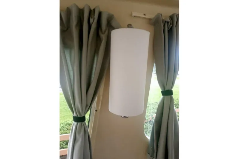 Slide: The Image of Curtains and light fixture inside 2005 Rosborough RF-246 Sedan Cruiser. - 68