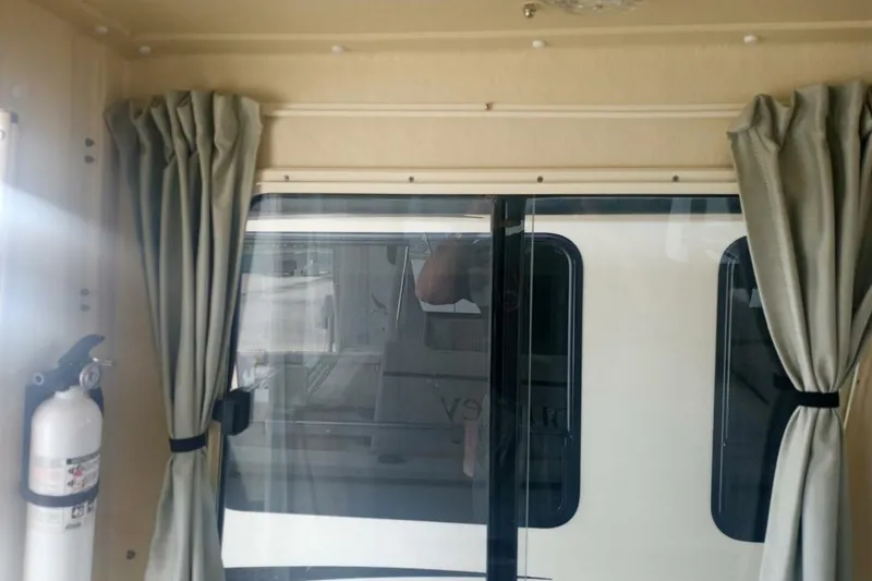 Slide: The Image of Interior view of 2005 Rosborough RF-246 Sedan Cruiser with curtains and fire extinguisher. - 69