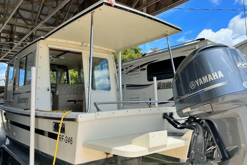 Slide: The Image of 2005 Rosborough RF-246 Sedan Cruiser with Yamaha outboard motor, docked under shelter. - 7
