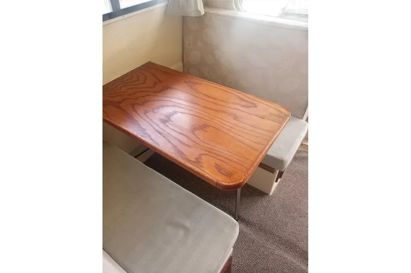 Slide: The Image of 2005 Rosborough RF-246 Sedan Cruiser interior with wooden table and cushioned seating. - 70
