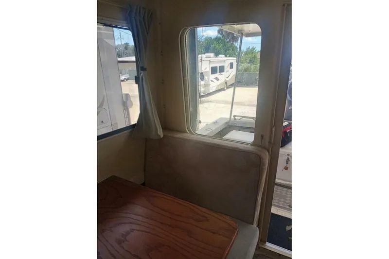 Slide: The Image of Interior view of 2005 Rosborough RF-246 Sedan Cruiser with window and wooden table. - 71