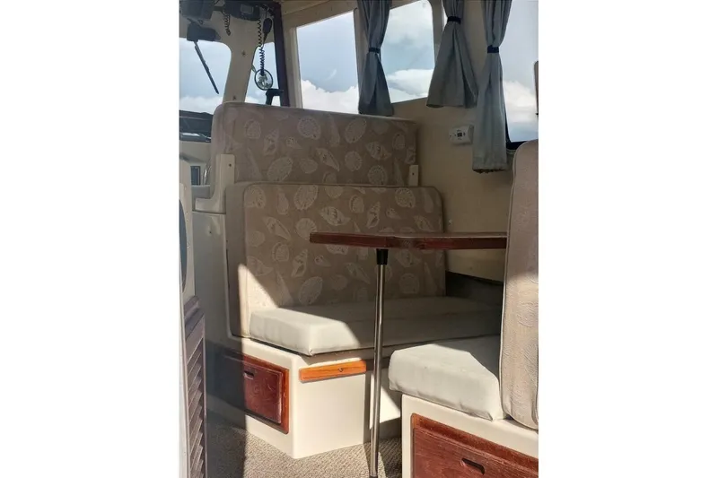 Slide: The Image of Interior of 2005 Rosborough RF-246 Sedan Cruiser with cushioned seating and wooden table. - 72