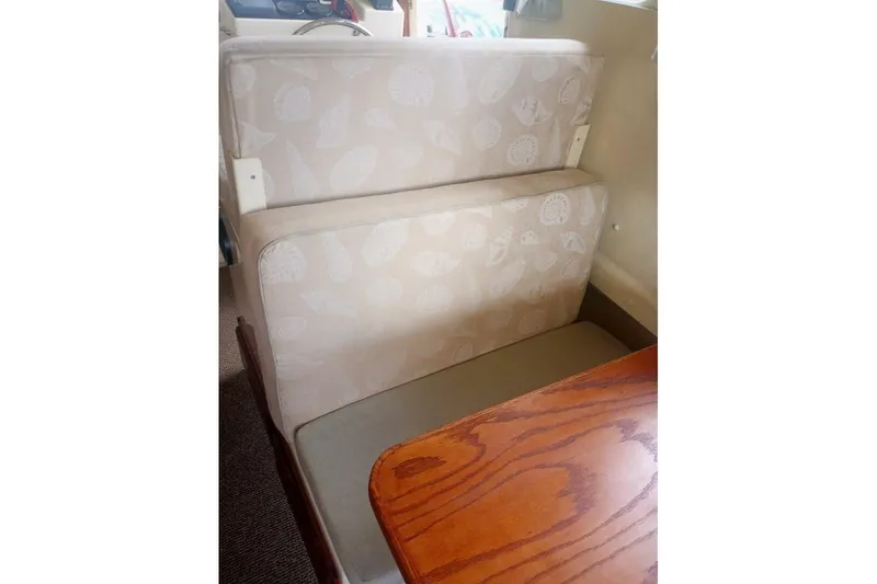 Slide: The Image of 2005 Rosborough RF-246 Sedan Cruiser interior with beige seating and wooden table. - 73