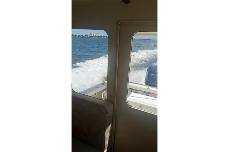 Slide: The Image of Interior view from a 2005 Rosborough RF-246 Sedan Cruiser, showing ocean waves and distant cityscape. - 74