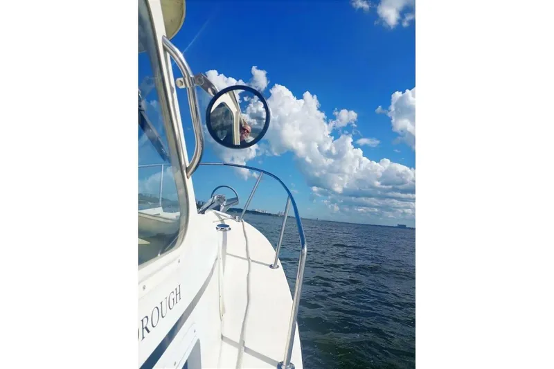 Slide: The Image of 2005 Rosborough RF-246 Sedan Cruiser on open water under a bright blue sky. - 75