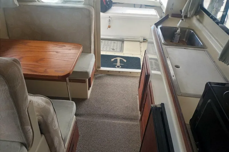 Slide: The Image of Interior of 2005 Rosborough RF-246 Sedan Cruiser with dining area and kitchenette. - 9