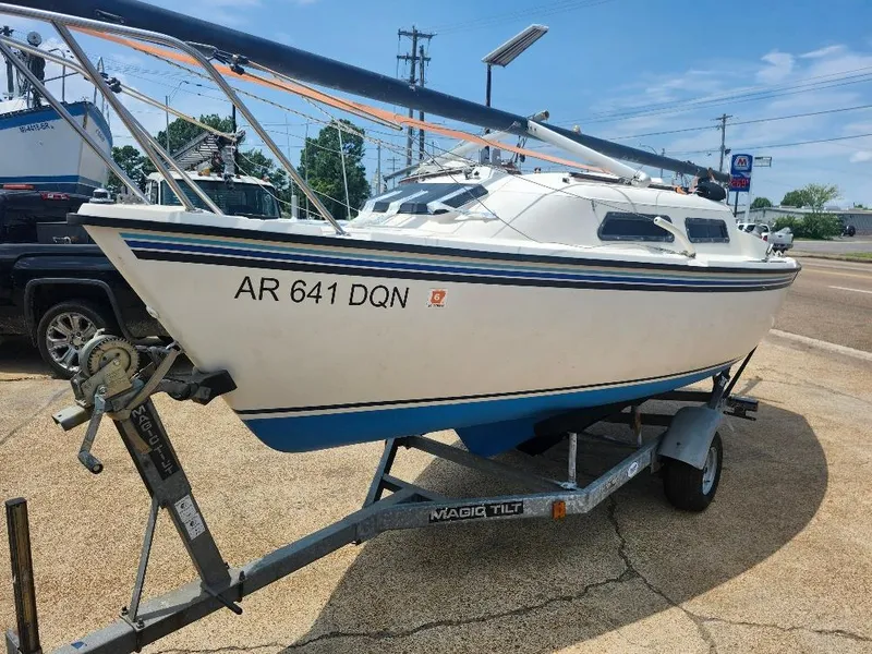 The Image of 1982 Starwind 19 sailboat on trailer, registration AR 641 DQN, parked outdoors. - 0