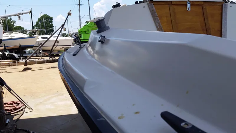 Slide: The Image of 1982 Starwind 19 sailboat in a boatyard, side view with other boats in background. - 10