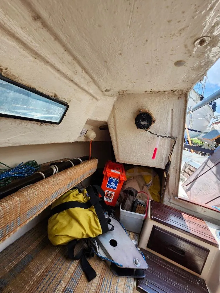 Slide: The Image of Interior of a 1982 Starwind 19 sailboat with gear and equipment stored. - 11
