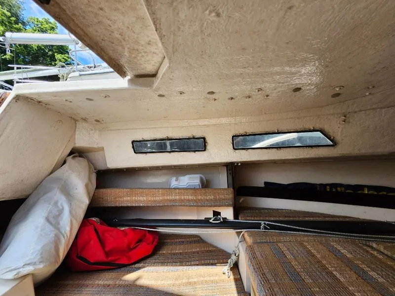 Slide: The Image of Interior of a 1982 Starwind 19 sailboat cabin with cushions and storage. - 12