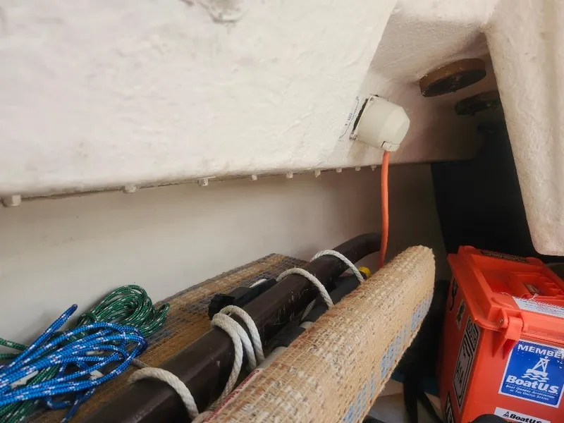 Slide: The Image of Interior of a 1982 Starwind 19 sailboat with ropes and safety equipment. - 16