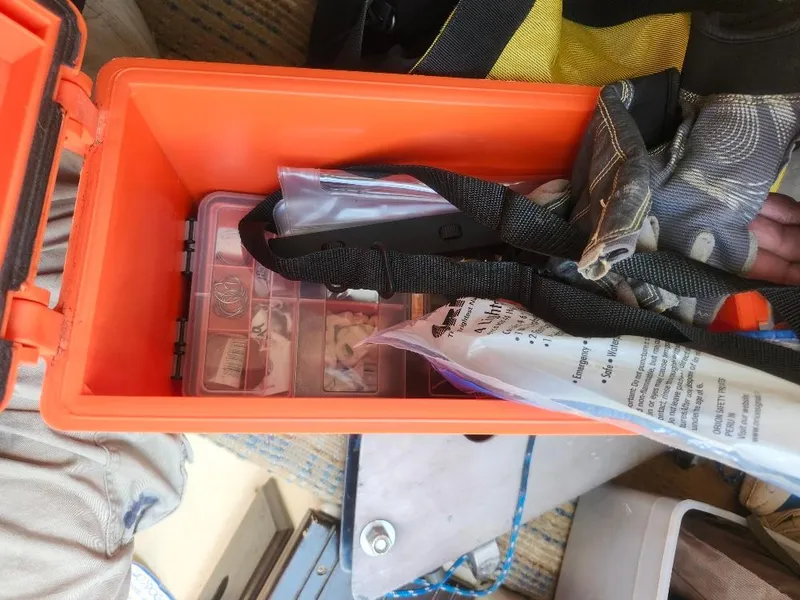 Slide: The Image of Orange toolbox with assorted tools and supplies, including gloves and a plastic organizer. Starwind 19, 1982. - 18