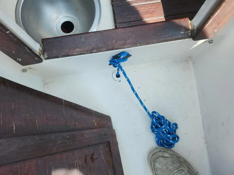 Slide: The Image of Interior of a 1982 Starwind 19 sailboat with blue rope and wooden flooring. - 19