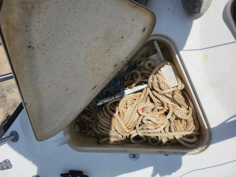 Slide: The Image of Open storage compartment on 1982 Starwind 19 boat with ropes and anchor inside. - 21