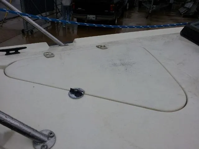 Slide: The Image of 1982 Starwind 19 sailboat deck with hatch and railing, docked on a rainy day. - 29