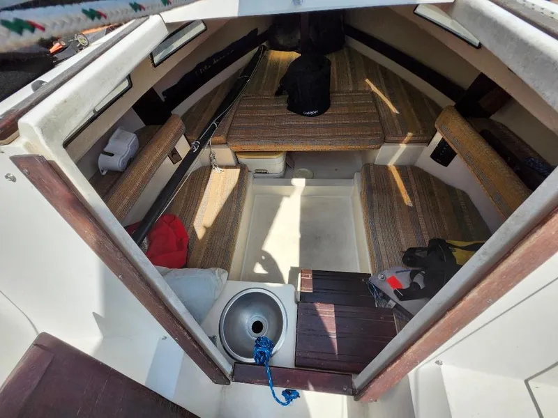 Slide: The Image of Interior of a 1982 Starwind 19 sailboat with seating and storage areas. - 3