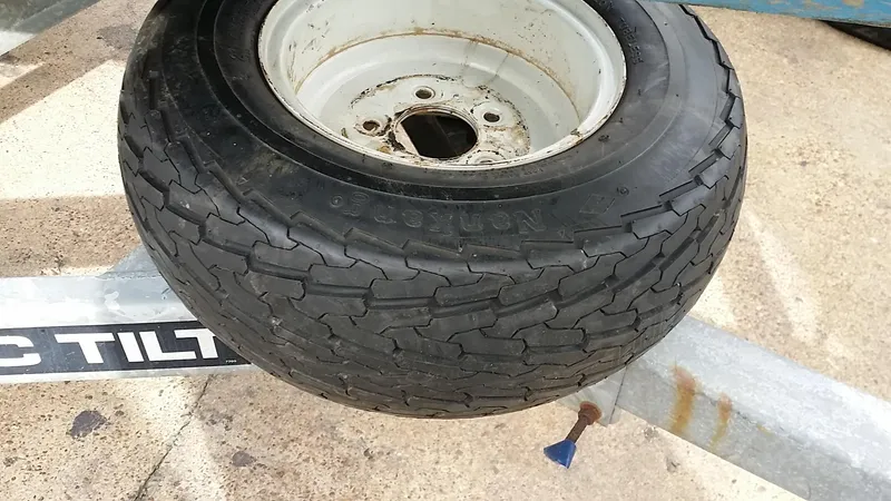 Slide: The Image of Trailer tire on a Starwind 19, 1982 model, mounted on a metal frame. - 32